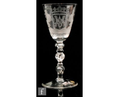 An 18th Century Newcastle light baluster drinking glass circa 1750, large round funnel bowl engraved with the Dutch Royal Coa