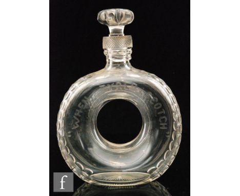 An early 20th Century Stevens &amp; Williams clear cut crystal decanter of donut form cut in the form of a car tyre with tyre
