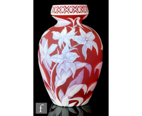 A late 19th Century Thomas Webb &amp; Sons Gem Cameo glass vase of footed ovoid form cased in opal over ruby and carved in re