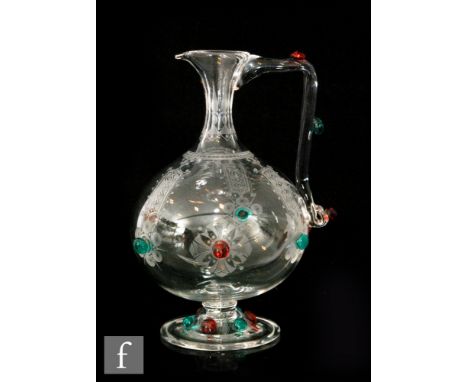 A mid 19th Century Stourbridge crystal glass jug in the manner of Dr Christopher Dresser of footed ovoid form with slender co