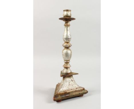 A SILVERED TURNED WOOD CANDLESTICK, on a triangular base. 13.5ins high.
