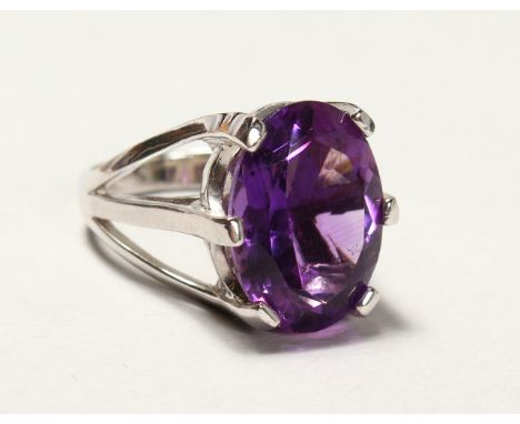 A LARGE SILVER REAL AMETHYST RING.