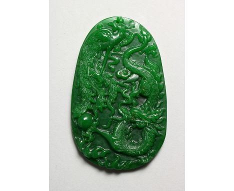 A LARGE CARVED APPLE GREEN JADE PENDANT. 3.75ins high.