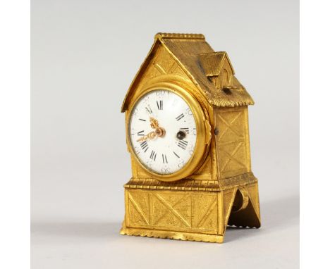 A MINIATURE ORMOLU CLOCK, modelled as a half timbered building with thatched roof. 3.25ins high.