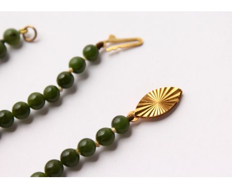 A JADE BEAD NECKLACE AND BRACELET, with 9ct gold clasps. Necklace 16.5ins long, bracelet 7ins long.