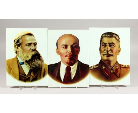 A SET OF THREE PORCELAIN PLAQUES, each printed digitally with an image of a Russian leader. Stalin, Marx and Lenin.12ins x 8.