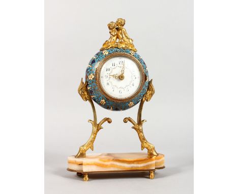 A SMALL FRENCH CHAMPLEVE ENAMEL DESK CLOCK, with cherub cresting, circular painted dial on an alabaster base (movement replac
