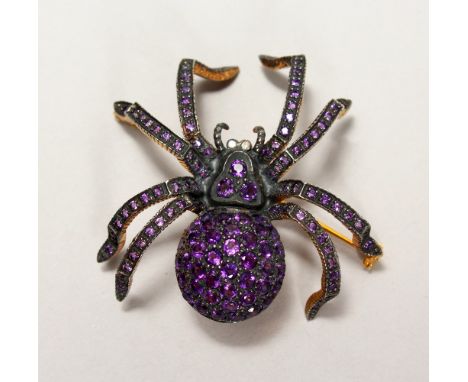 A 9CT GOLD AND SILVER SPIDER BROOCH, set with amethyst and diamonds.