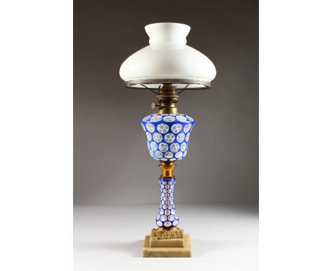 A 19TH CENTURY BOHEMIAN BLUE AND WHITE OVERLAY OIL LAMP, with reservoir and stem, with white glass shade.