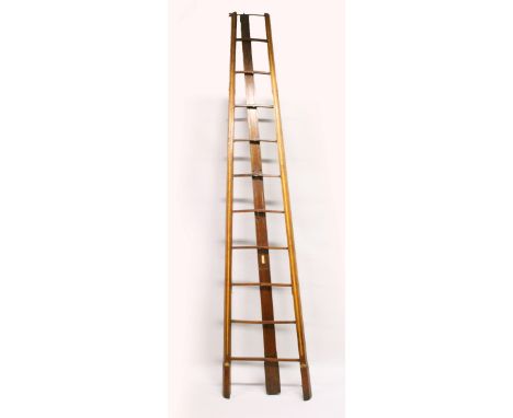 A VERY GOOD VICTORIAN GOTHIC REVIVAL MAHOGANY FOLDING LIBRARY LADDER, with fluted, parcel gilded sides and rear strut, openin