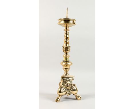 AN 18TH/19TH CENTURY CAST BRASS PRICKET STYLE CANDELABRA, on three claw and ball feet. 1ft 7ins high.