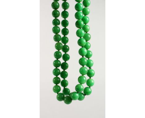 A STRING OF JADE BEADS. 34ins long.