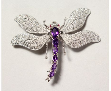 A SILVER, RUBY AND AMETHYST SET DRAGONFLY BROOCH.