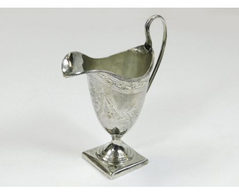 GEORGIAN CREAM JUG. A George III silver cream jug with floral swag engraving & an initialled cartouche. Over-struck mark of G