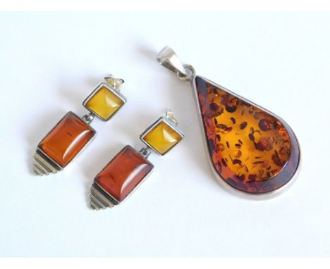 AMBER. A modern silver mounted amber pendant & a pair of Polish, silver mounted amber drop earrings. Please note that all ite