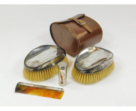 SILVER BRUSHES ETC. A pair of silver mounted bristle brushes, with engraved inscription & matching silver mounted comb in lea