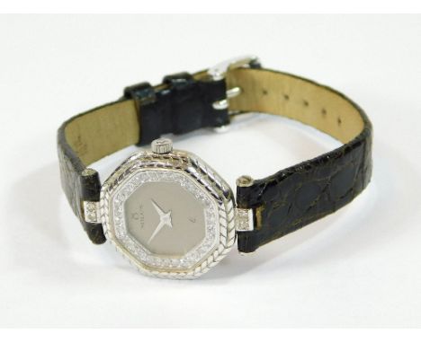 MILUS. A lady's 18ct. gold cased Milus wristwatch, with diamond set chapter ring. Dial diameter 2.5cm.All watches in this auc