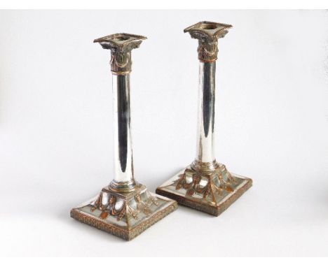 CANDLESTICKS. A pair of Sheffield plated Corinthian column candlesticks. Height 26.5cm (one of the removable sconces with det