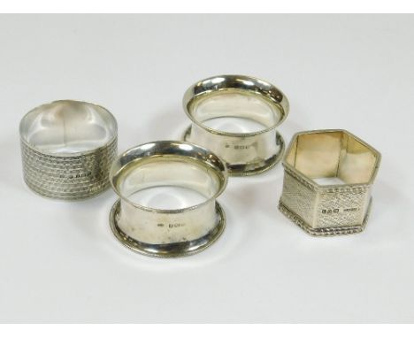 NAPKIN RINGS. A pair of silver waisted napkin rings, Birmingham 1916. Also, two engine turned napkin rings. Approx. 110g. (3.