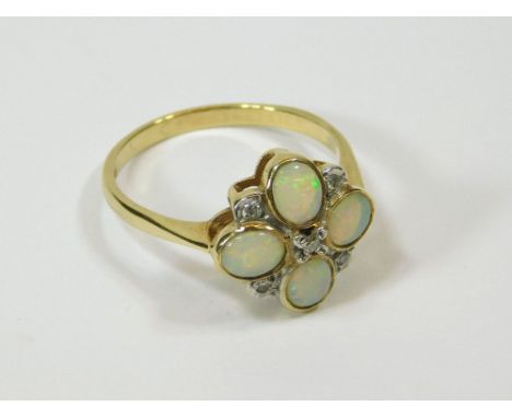 OPAL RING. A 9ct. gold, opal and diamond set flower-head ring. Size P. Please note that all items in this auction are previou