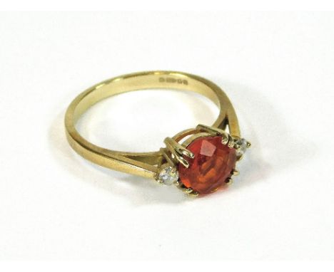 FIRE OPAL. A 9ct. gold fire opal & diamond ring. Size L/M. Please note that all items in this auction are previously owned & 