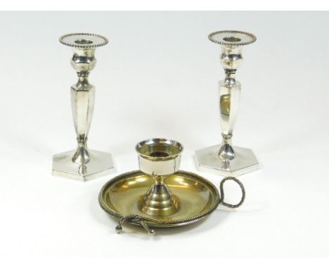 CANDLESTICKS ETC. A pair of Northern Goldsmiths EPNS candlesticks, height 18cm. Also, an EPNS chamber stick with rope twist b