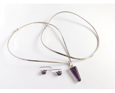 MEXICAN SILVER. Two Mexican silver shaped necklets, one hung with a triangular silver drop, set an amethyst coloured stone. A