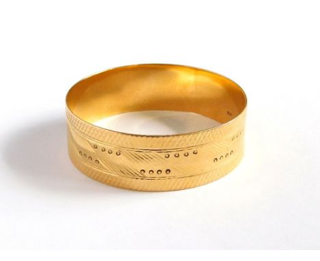 AFRICAN BANGLE. An African, 18ct. gold bangle with engraved & punched decoration. Approx. 58.2g. Please note that all items i