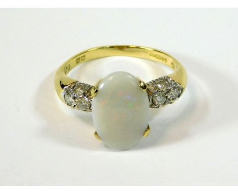 OPAL RING An 18ct. gold, white opal set ring, each shoulder set a group of four diamonds. Approx. 4.2g. Size O. Please note t