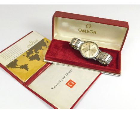 OMEGA. A gentleman's 1970s Omega stainless steel wristwatch. The champagne dial with baton numerals & sweep seconds hand. Rep