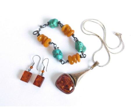 AMBER. A modern silver mounted amber pendant on silver chain & a pair of modern amber drop earrings. Also, an ethnic amber & 