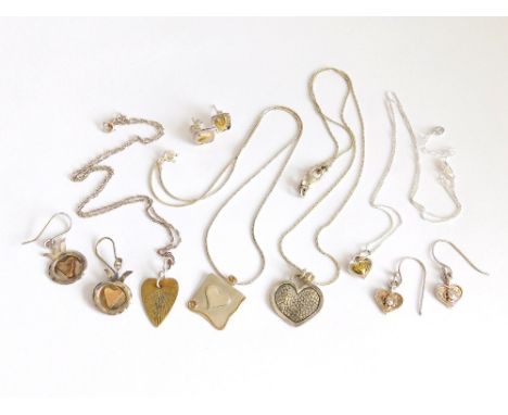 SILVER PENDANTS. Four silver & silver gilt heart pendants on silver chains & three pairs of heart shaped earrings. Please not