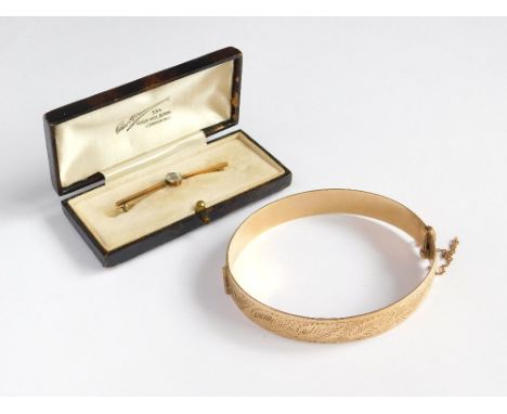 BAR BROOCH ETC. A bar brooch set a colourless stone, in fitted box. Also, a rolled gold bangle. Please note that all items in