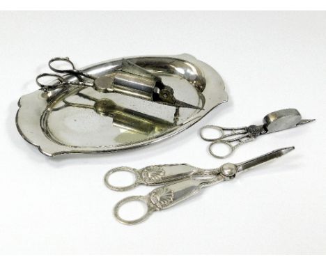 CANDLE SNUFFERS ETC. Two pairs of Georgian candle snuffers, a pair of EPNS grape scissors & a small oval tray.Please note tha