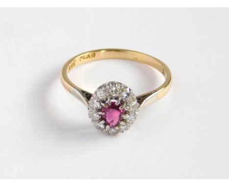 DIAMOND RING. An 18ct. gold & palladium (Plad) ruby & diamond cluster ring. Size P/Q.Please note that all items in this aucti