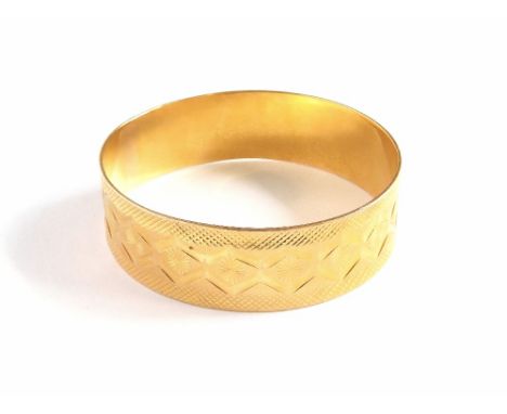 GOLD BANGLE. An African 18ct. gold (unmarked but with the same provenance as the previous lot), with geometric engraving. App