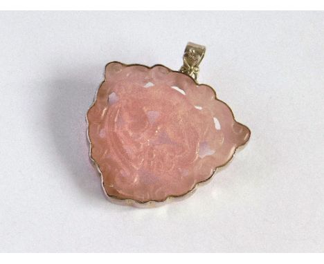 JADE PENDANT. A Chinese silver mounted, carved pink jade pendant. Max. width 6cm, length including loop 7cm. (Slight fracture