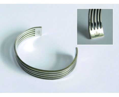 GUCCI. A silver open ended bangle by Gucci, stamped.Please note that all items in this auction are previously owned & are off