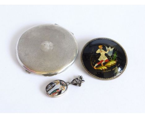RUSSIAN LACQUER ETC. A Russian lacquered brooch, signed, 5.4cm. Also, a silver mounted Greek Orthodox ceramic pendant & a sil