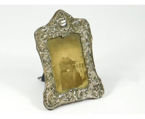 SILVER FRAME. A Victorian embossed silver photograph frame. (Strut worn).Please note that all items in this auction are previ