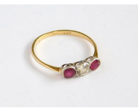 RUBY & DIAMOND RING. An 18ct. gold & platinum, three stone ruby & diamond ring. Size P/Q. Please note that all items in this 