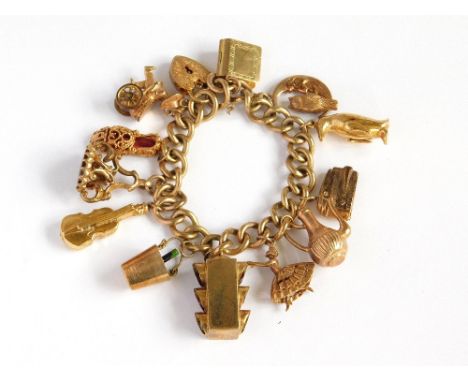CHARM BRACELET. A substantial, 9ct. gold curb link bracelet with engraved 9ct. gold padlock clasp. Hung with twelve hallmarke