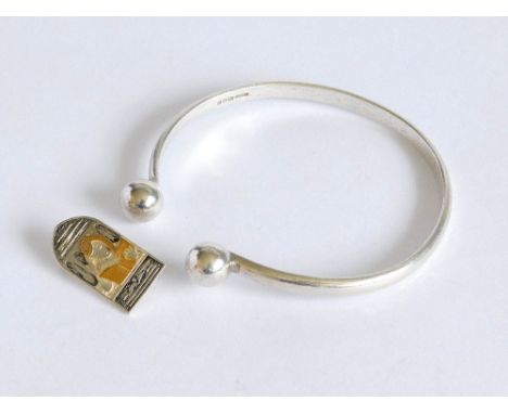 SILVER BANGLE ETC. A hammered silver torque bangle & a pin for The Hypatia Trust. Please note that all items in this auction 