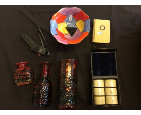 Three red glass vases, with a Bizarre Clarice Cliff style bowl on stand, shaving knife, small bible and napkin rings.