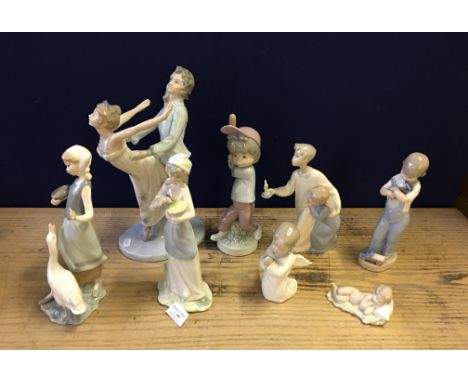 A group of figures to include large Nao figure of a dancing couple, with six other Lladro smaller examples together with a si