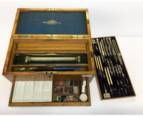An early 20th Century oak cased Stanley protractor graphical drawing set with removable layers including rulers, paints, angl