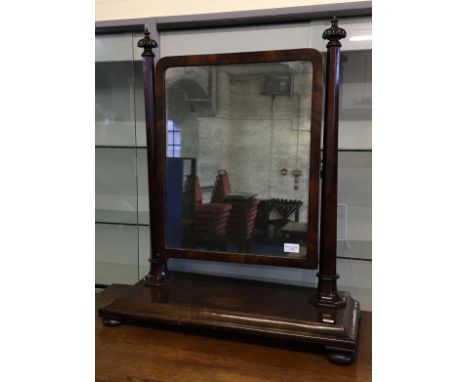 A 19th Century mahogany swing mirror with octagonal pillar supports.
