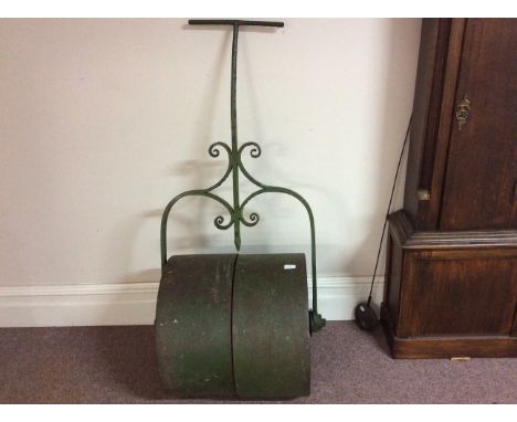 A green garden roller.
