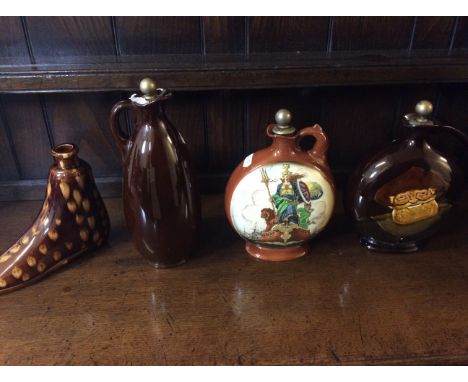 Three Royal Doulton whiskey decanters with a similar decanter in the form of a shoe.