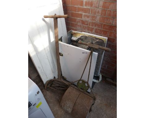 Iron crete vintage cast metal roller and vintage push lawnmower